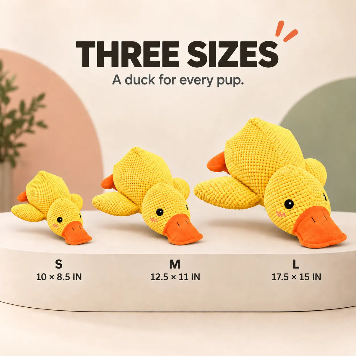 Three crocheted yellow duck toys in small, medium, and large sizes displayed on a white pedestal with size measurements labeled underneath. Text at the top reads 'THREE SIZES A duck for every pup.